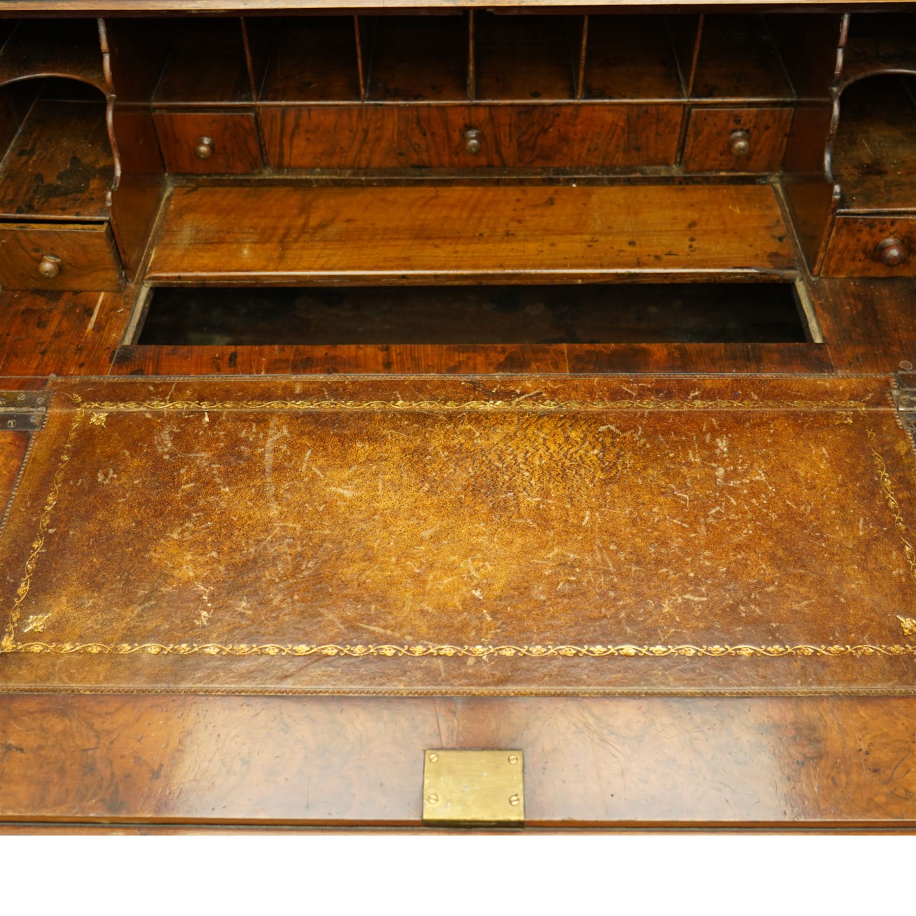 Queen Anne burr walnut chest on stand, moulded projecting cornice over arched mirror glazed doors, above a sloping fall front enclosing fitted interior with pigeonholes and correspondence drawers, fitted with foliate brass escutcheons, shaped apron over tapered baluster turned supports united by curved stretchers, early 18th century with later restorations 