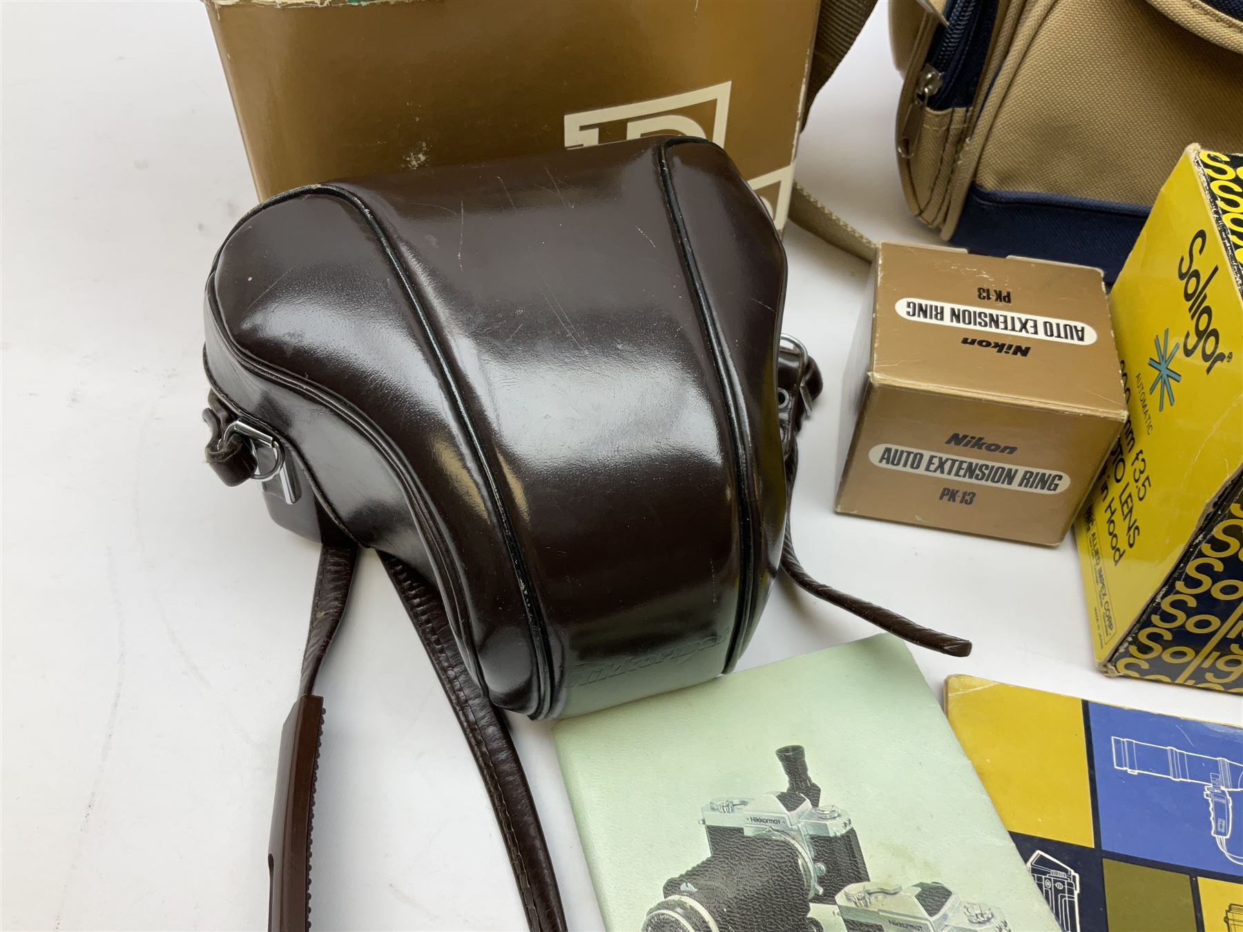 Cameras and accessories including Nikon Nikkormat camera with ‘Nikkor-H 1:2 f=50mm’ lens, Olympus C-8080 wide zoom digital camera, soft case camera bag etc, all untested, in one box