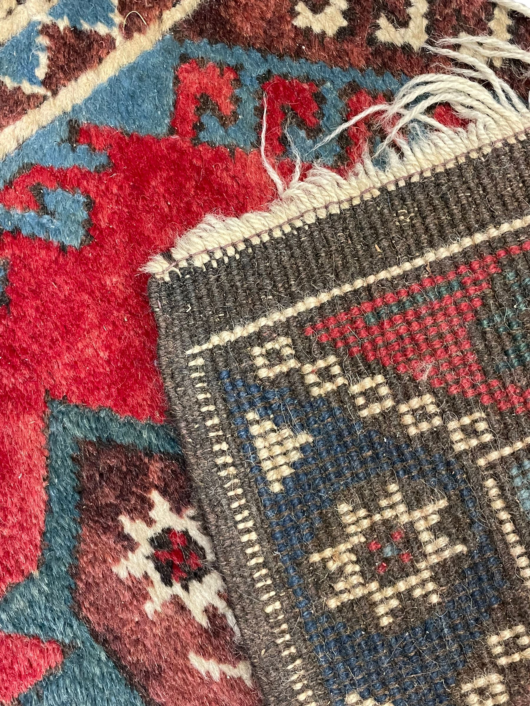 Turkish red ground runner, seven star and leaf decorated medallions, geometric design repeating border