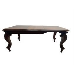 Victorian mahogany extending dining table, moulded rectangular top with rounded corners, telescopic mechanism with leaf and winding handle, on leaf and cartouche carved cabriole supports, brass and ceramic castors