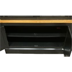 Contemporary polished pine and black finish break-front bookcase, projecting cornice over globular mounts, central cabinet enclosed by two glazed doors over double panelled cupboard, flanked by adjustable shelves, on plinth base