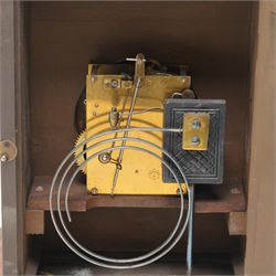 German-Junghans late 19th century oak cased mantle clock, with a domed pediment and three matching turned finials, break arch door beneath with attached turned and tapered pilasters, brass dial with cast spandrels, matted dial centre, steel hands and silvered chapter ring with Roman numerals, two train movement striking the hours and half-hours on a coiled gong. With pendulum and key.