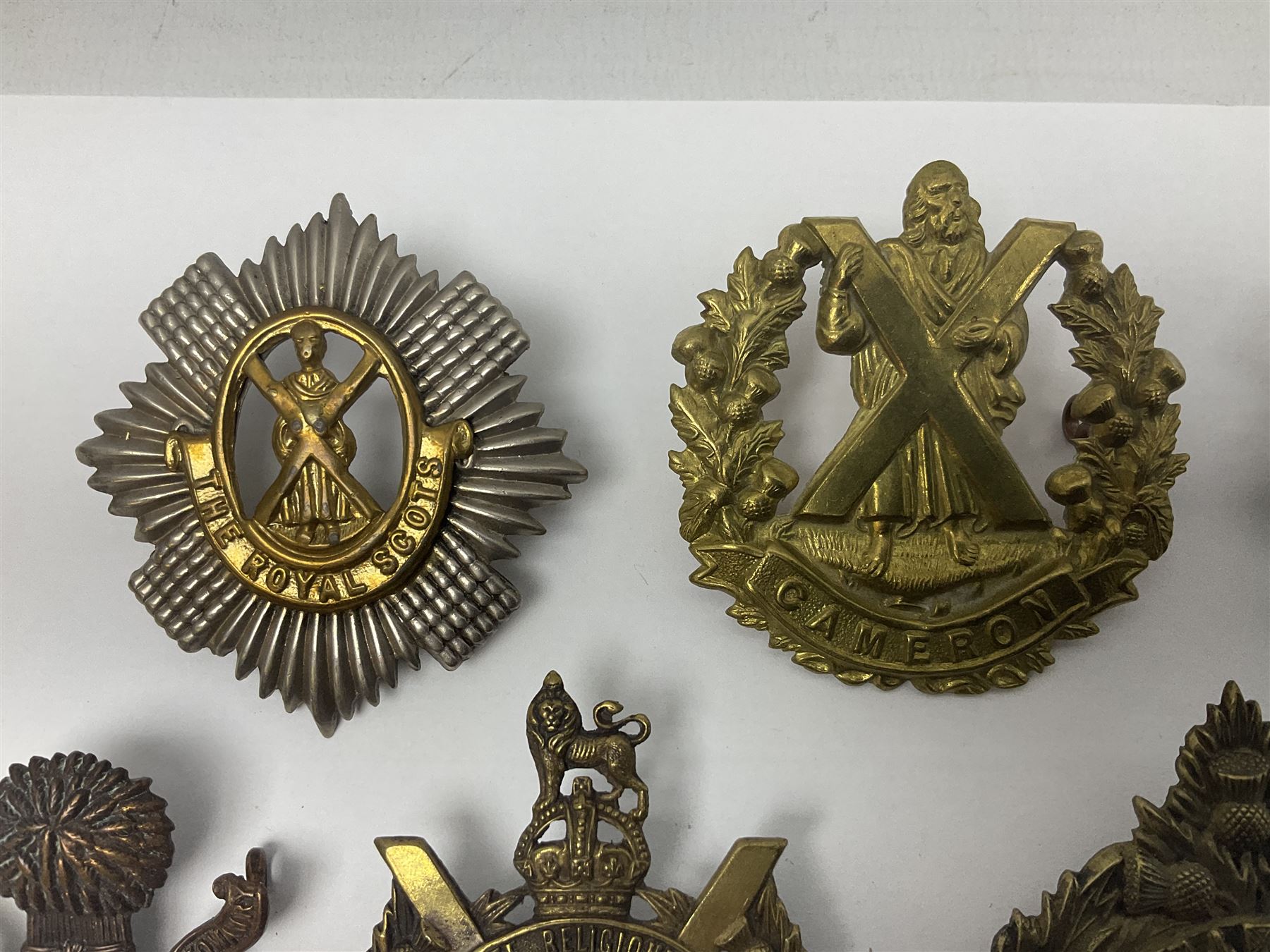 Fifteen Scottish Glengarry and other metal military badges including Argyll & Sutherland, Royal Glasgow Yeomanry, Cameronians, Lanarkshire Yeomanry, Kings Scottish Own Borderers, Highland Light Infantry, Border Regiment, Lowland Regiment, Lothians & Border Horse Yeomanry, Ayrshire Earl of Carricks Own Yeomanry etc