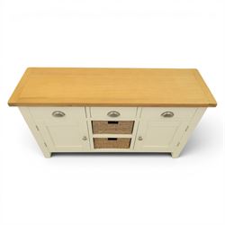 Contemporary white painted sideboard, oak veneered top above three drawers with metal cup handles, two central rattan drawers flanked by cupboards