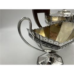 Victorian silver four piece tea service, comprising teapot, teapot stand, twin handled open sucrier and milk jug, each of octagonal form with foliate bud border and engraved decoration including crest to canted panels, and vacant panels, the teapot with ivory finial to the hinged cover and later wooden handle, hallmarked Edward Barnard & Sons Ltd, London1896, teapot including finial H15cm, milk jug including handle H16cm, teapot stand W11.5cm

This item has been registered for sale under Section 10 of the APHA Ivory Act