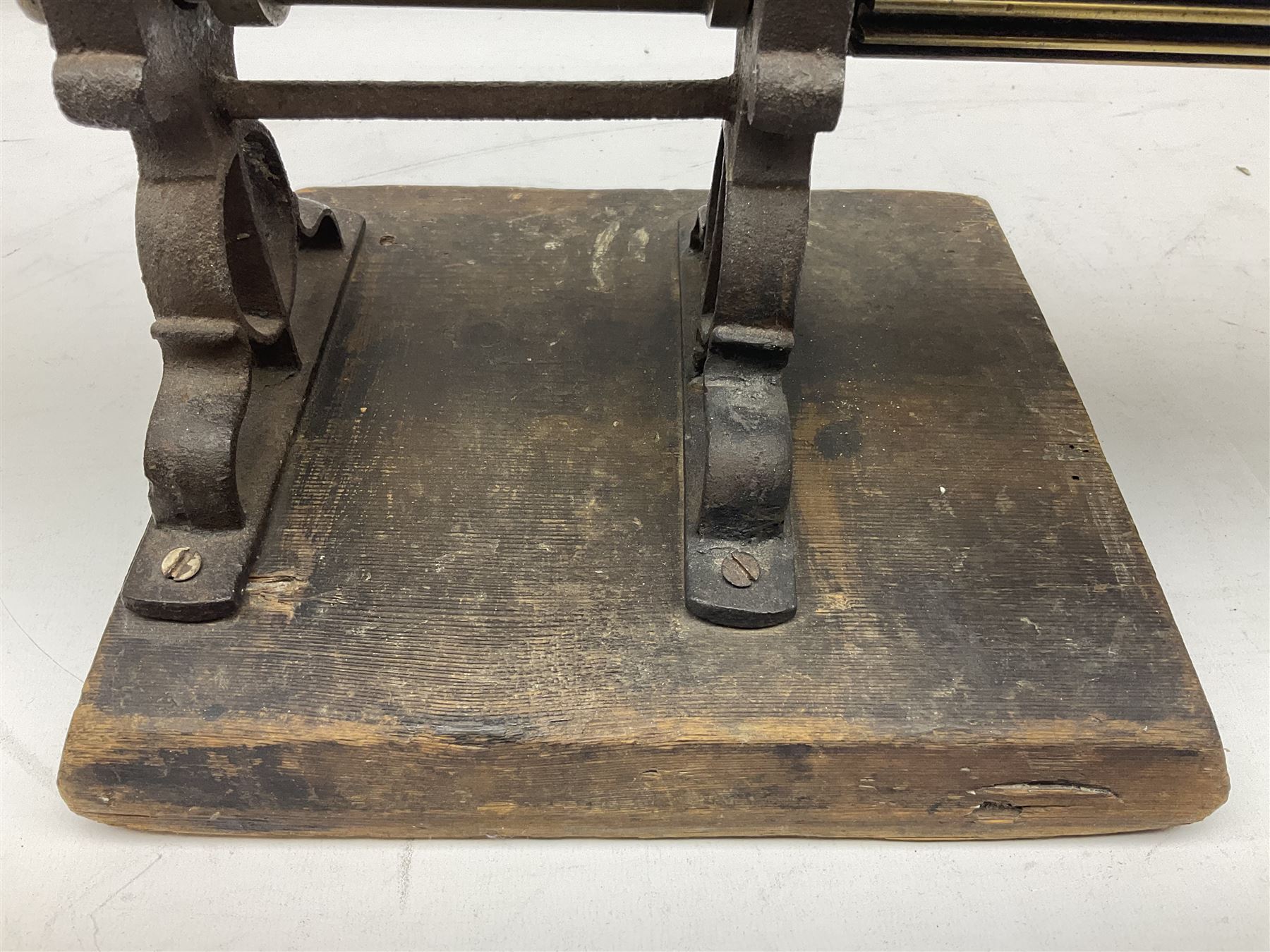 Victorian cuff and collar tabletop mangle, the ribbed brass rollers in a cast iron frame mounted on a wooden base