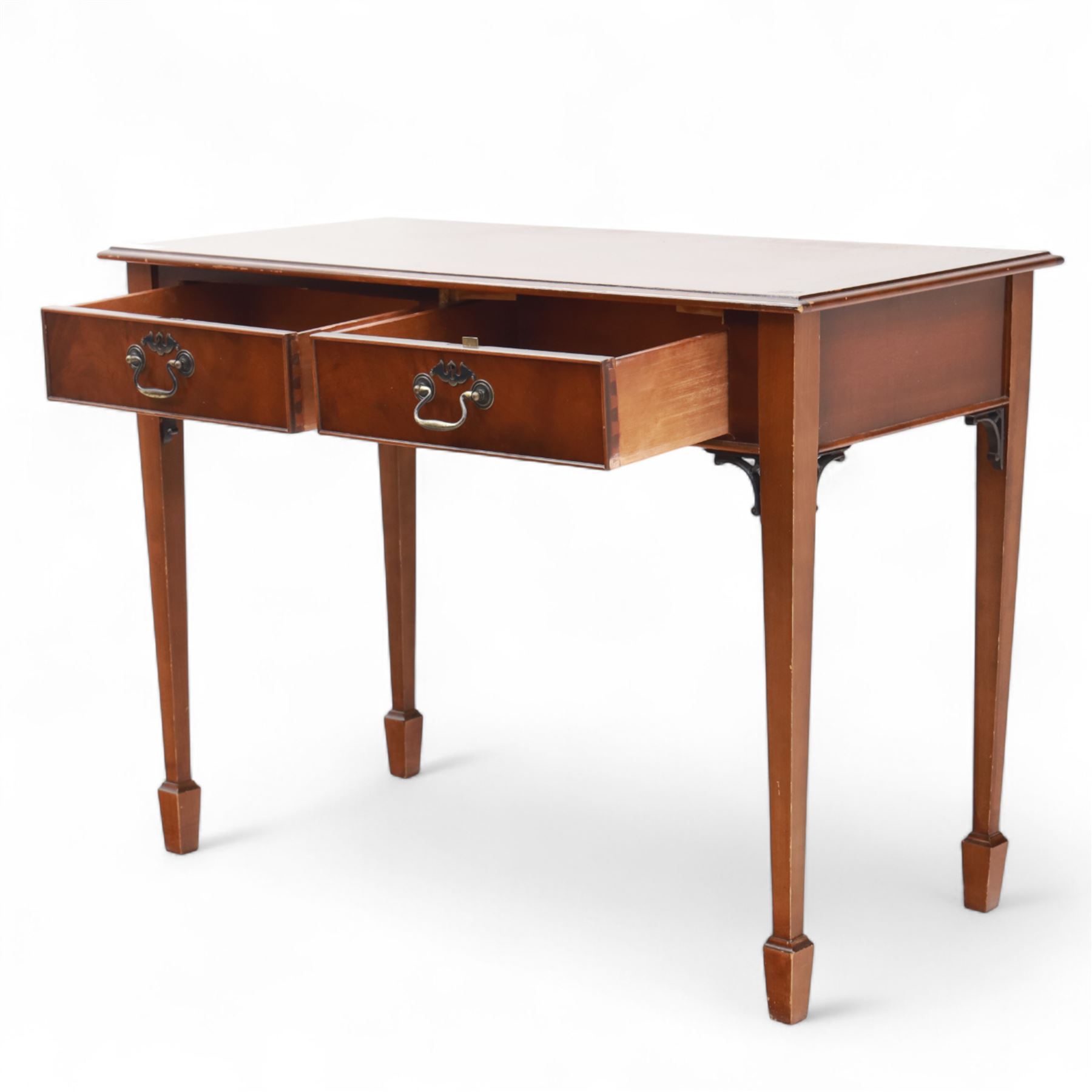 Edwardian design mahogany desk, crossbanded rectangular top above twin drawers with brass handles, raised on square tapering legs terminating in spade feet