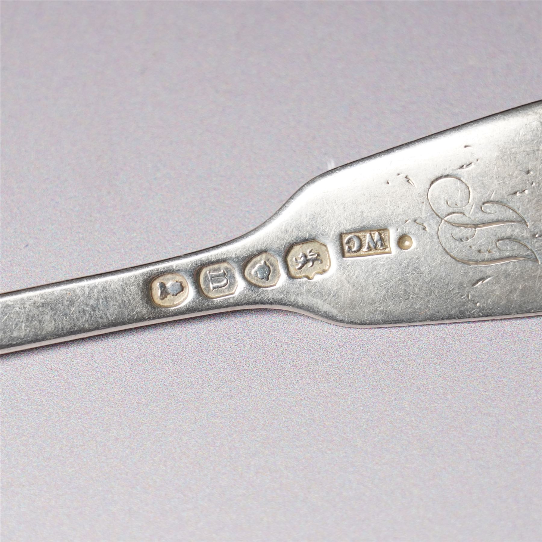 Four Victorian silver dessert spoons engraved with initials Exeter 1877 Maker Josiah Williams & Co and four George IV silver fiddle and shell pattern dessert forks London 1828 Maker William Chawner 