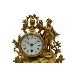 A late 19th century French 8-day timepiece mantle clock in a spelter case on an ebonised oval plinth, with a white enamel dial, Roman  numerals and minute markers, steel spade hands with an unglazed beaded bezel, the spring driven drum movement housed in a gilt spelter rococo designed case with a figure of a young gallant.
With pendulum, no key.
