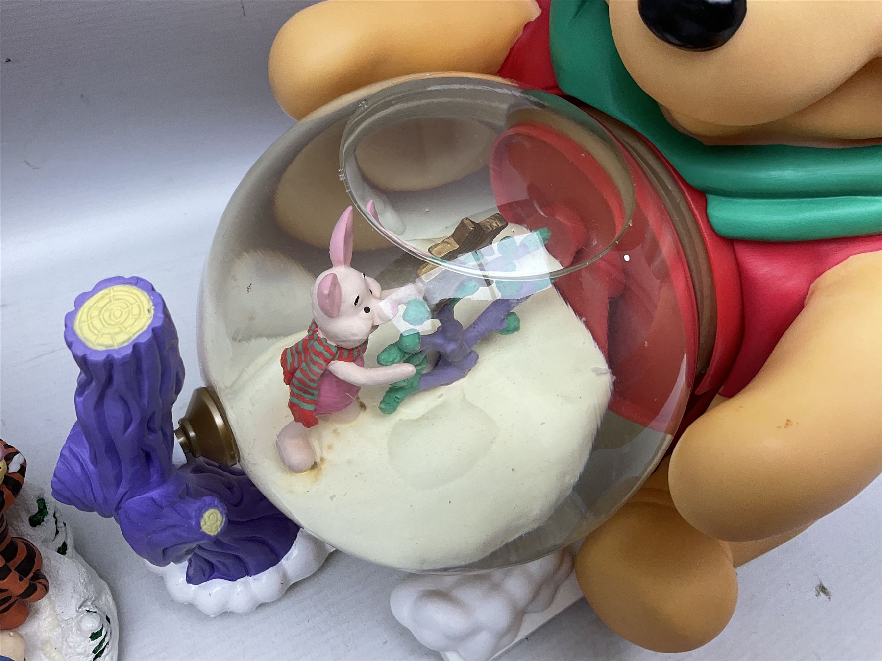 Six Disney Winnie the Pooh Christmas snow globes, comprising large Mr Christmas Holiday Snowfall, An Enchanted Christmas, It's A Small World Christmas 1994,  Tree Trimming, 1995 Christmas At Our House and Christmas Band Concert, together with Mr Christmas Holiday Go Round, all with boxes (7)