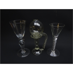  Air twist stem wine glass with trumpet on domed foot, H15.5cm, wine goblet with pointed round funnel bowl above ball knop and four sided teared Silesian stem with on folded foot, H18.5cm and glass lace makers lamp, globular reservoir, twisted handle, slightly ribbed stem with tear inclusions on domed folded base (3)  