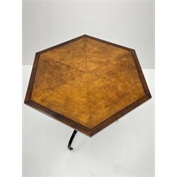 Regency style birdseye maple and rosewood tripod table, hexagonal tilt top with segmented veneer and banding, tapered hexagonal column on three splayed serpentine supports, brass cups and castors 