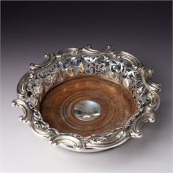 18th century Sheffield plate wine funnel by Roberts, Cadman & Co with bell mark, two other plated wine funnels and a Victorian plated bottle coaster by Elkington & Co with pierced decoration and turned wooden base (4) 