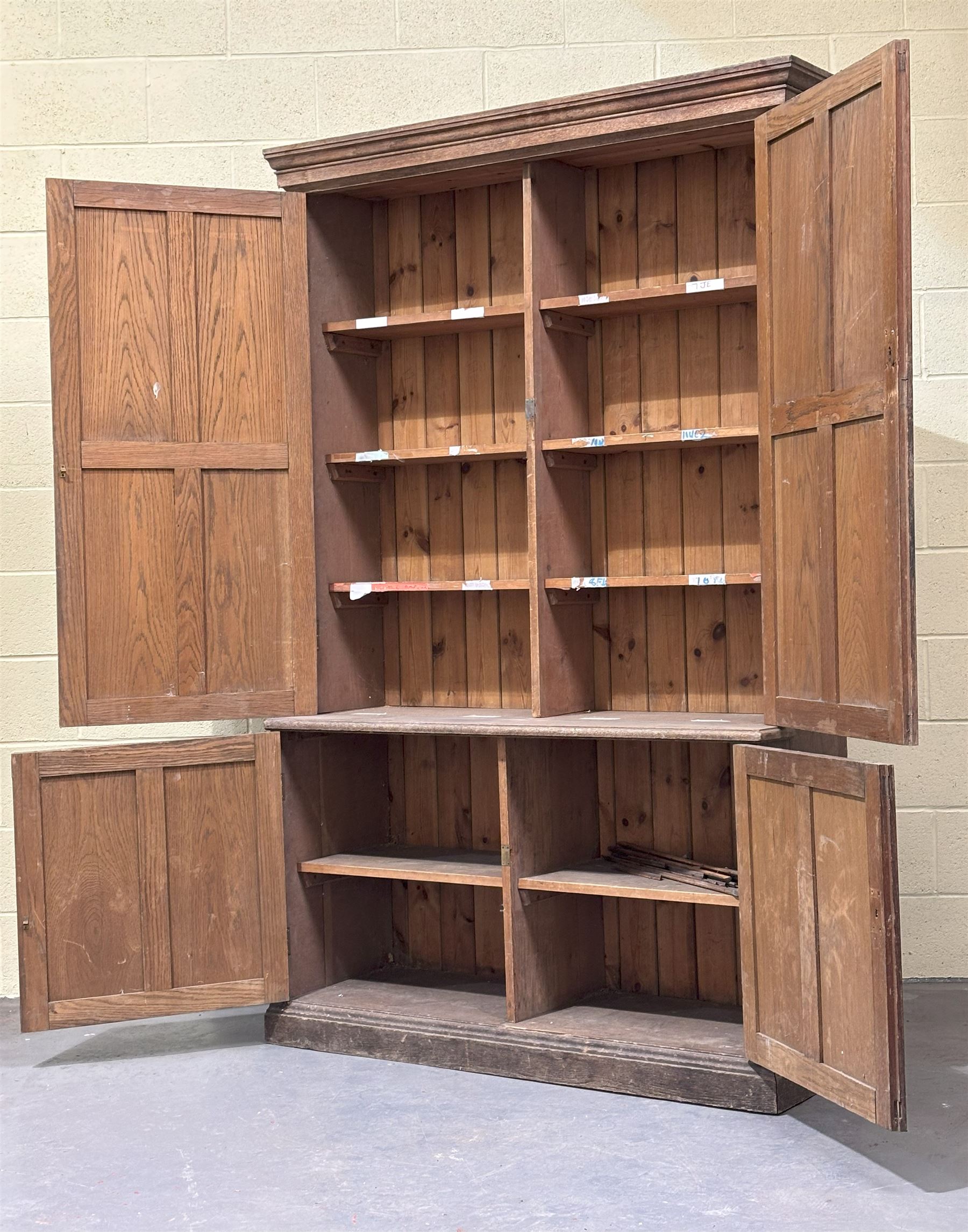 Late Victorian oak cupboard, the moulded cornice above two panelled doors, each enclosing three shelves, the base with two further doors opening to shelves behind. H214cm, W130cm, D48cm. - COLLECTION BY APPOINTMENT FROM: The White House, Thirsk Road, Easingwold, York, YO61 3NF - CALL 01723 507111 TO ARRANGE