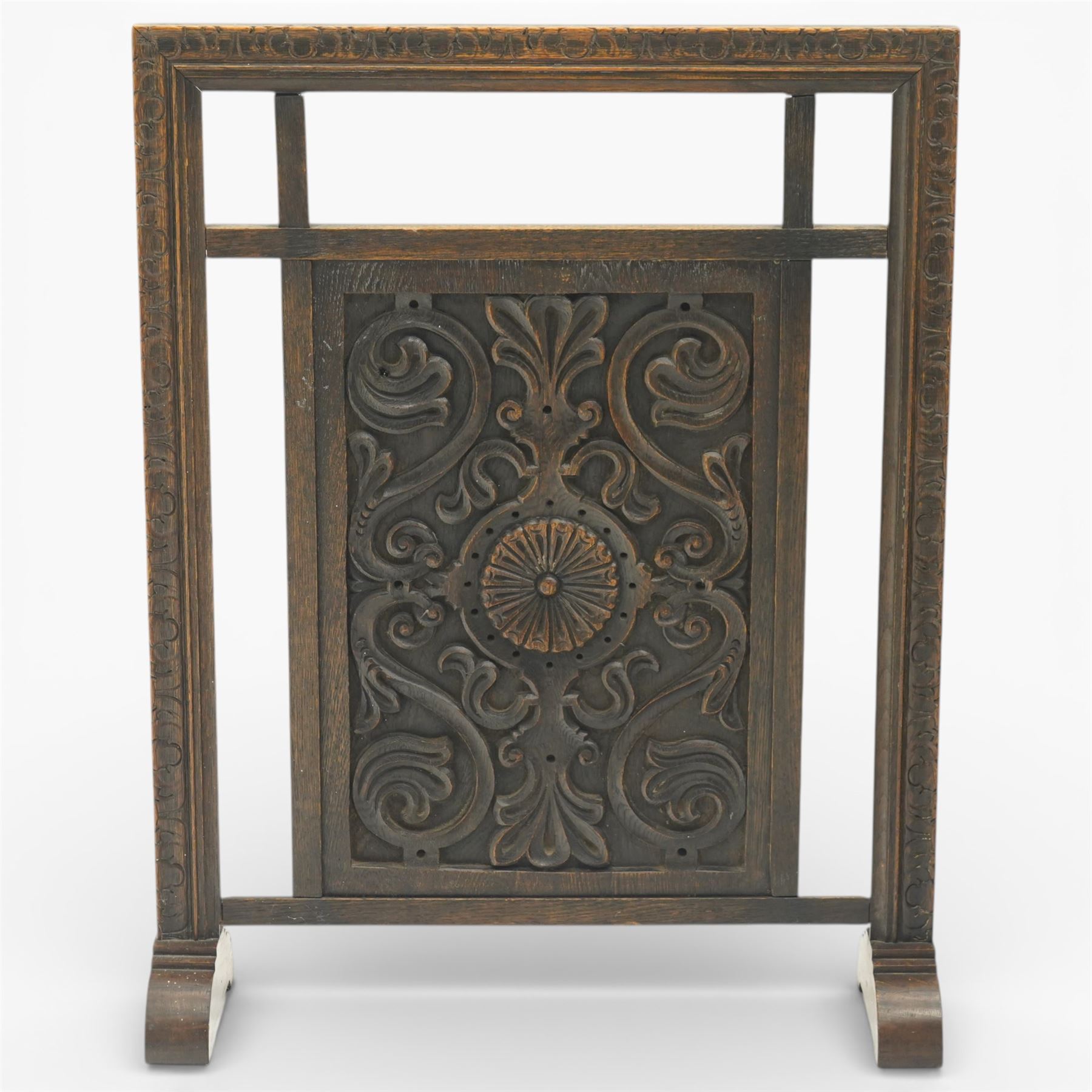 20th century carved fireside accessories; a carved coal bucket with metal liner and a carved fire screen