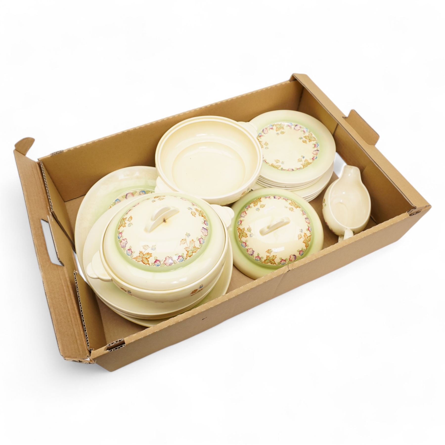 Clarice Cliff part dinner service, decorated with floral sprigs, including two covered tureens, six dinner plates, serving platter etc