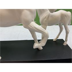Five Beswick and Royal Doulton horse figures in matt white on black plinths, comprising of  Spirit of Affection no. 2689/2536, Springtime no.2837, Spirit of peace no.2916, Spirit of earth no.2914 and Spirit of the wild no. 183, together with a composite figure of a horse (6)