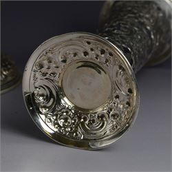 Three late 19th century/early 20th century silver vases, of trumpet form, all embossed with floral and foliate decoration, one example with weighted base, all hallmarked, tallest H18cm