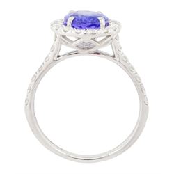 Platinum tanzanite and diamond cluster ring, single oval tanzanite of 2.36 carat, with round brilliant cut diamond surround and diamond set shoulders, hallmarked, total diamond weight 0.76 carat, with World Gemological Institute report