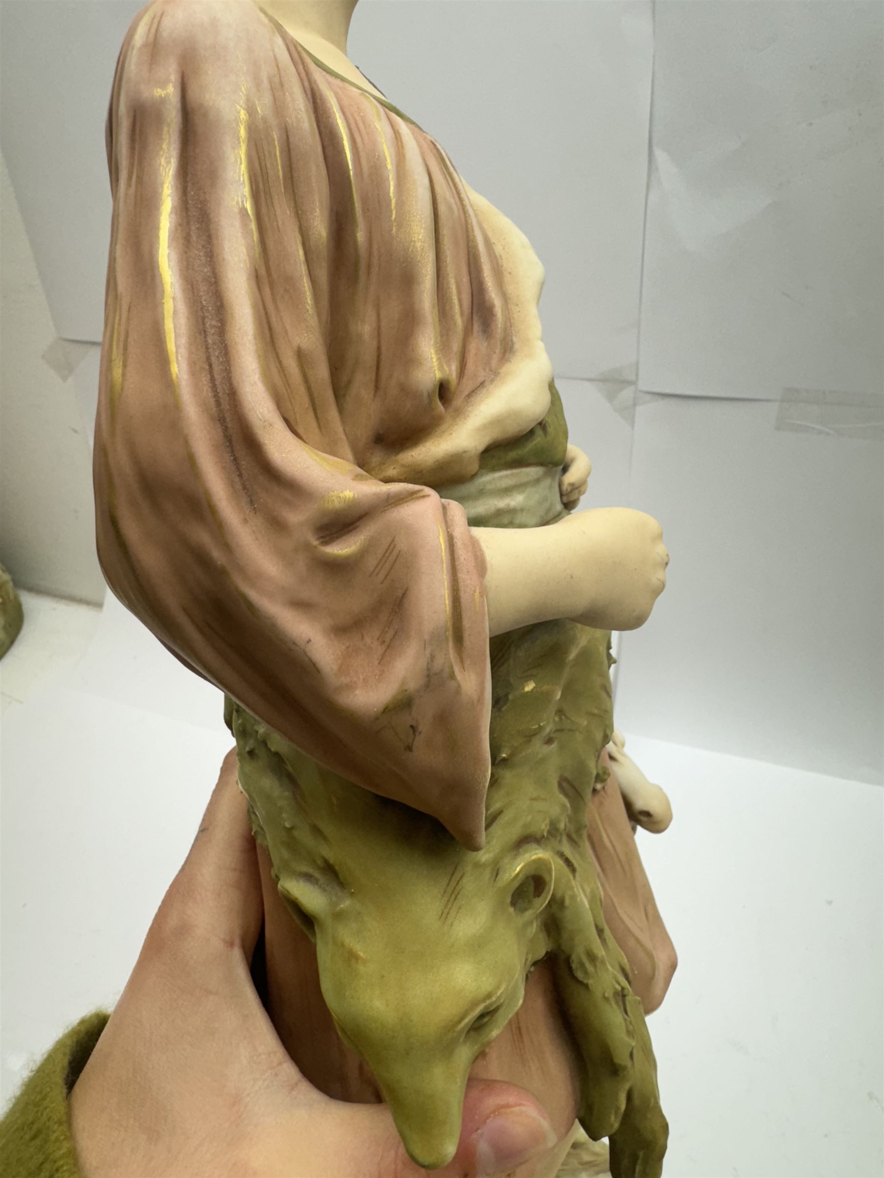 Pair of Royal Dux figures, no. 1115, modelled as a shepherd with a goat by his side and a shepherdess feeding a lamb, each wearing flowing green and pink robes with gilt detailing, with pink triangle mark beneath, H51cm