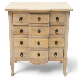 ML DS OKA - French design chest of drawers with limed oak finish, moulded breakfront top over four long drawers with metal ring handles and decorative escutcheons, panelled sides and shaped apron, on cabriole supports