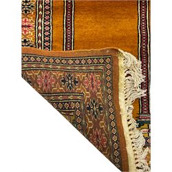 Angle-poise lamp and an Islamic prayer mat