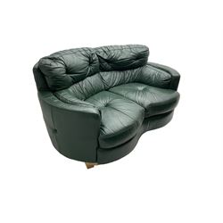 Two seat serpentine sofa, upholstered in green buttoned leather