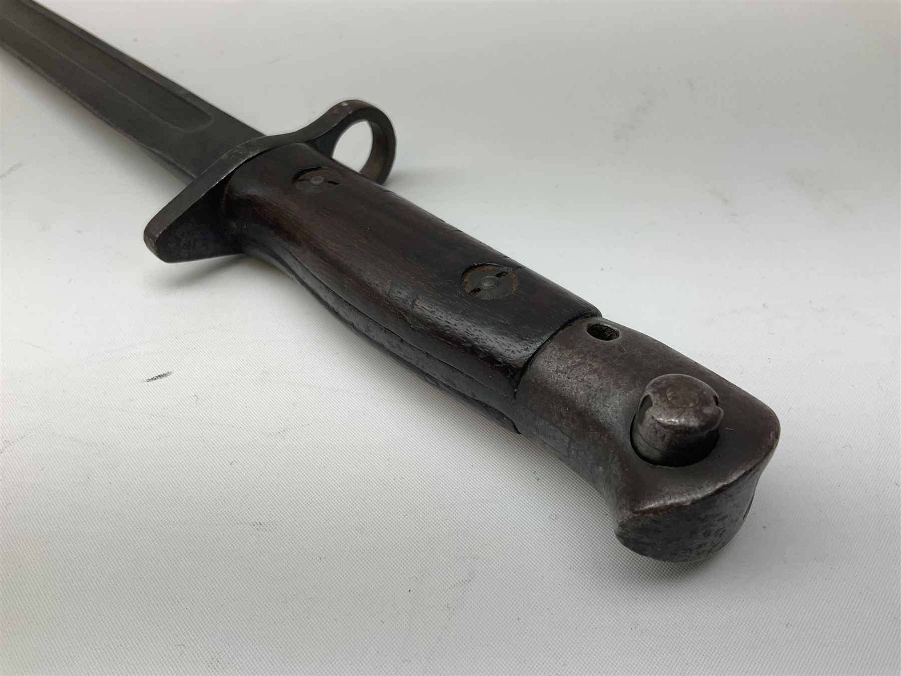 British Enfield 1907 model SMLE bayonet, with 43cm fullered steel blade and metal mounted leather scabbard L58cm overall; and Schmidt-Rubin Model 1918 bayonet the 30cm steel blade marked Elsener Schwyz No.579722; in steel scabbard with leather frog marked G. Bertolini Sellaio Vira/G.Tic 79 L45cm overall (2)