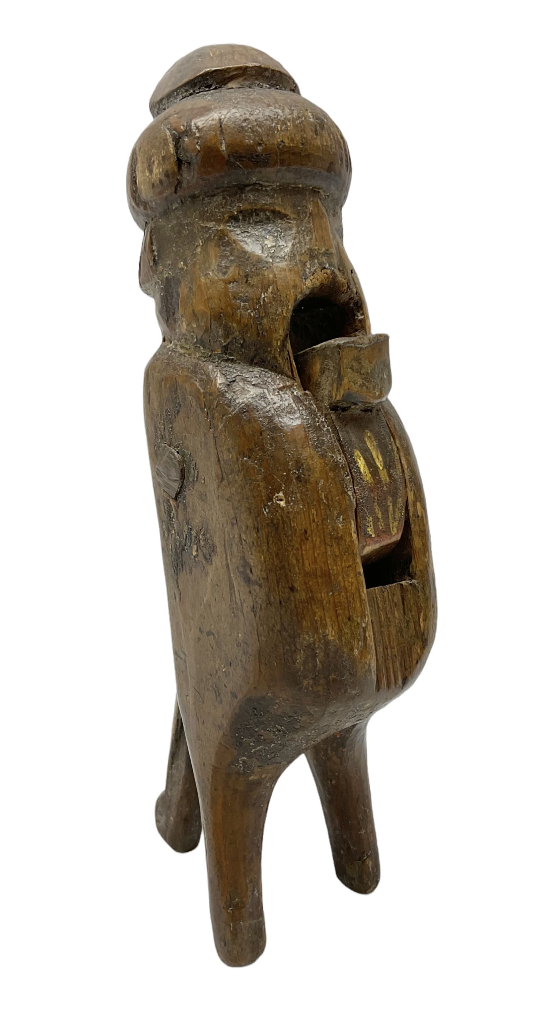 Rare primitive treen lever action nutcracker, probably late 17th/early 18th century, carved in the form of a man, with old collector label to side inscribed 'A Nutcracker XVI Century', H18cm