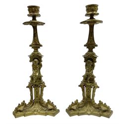 Pair of 19th century gilded candlesticks, the column depicting seated putti, raised on triform base, H27.5cm