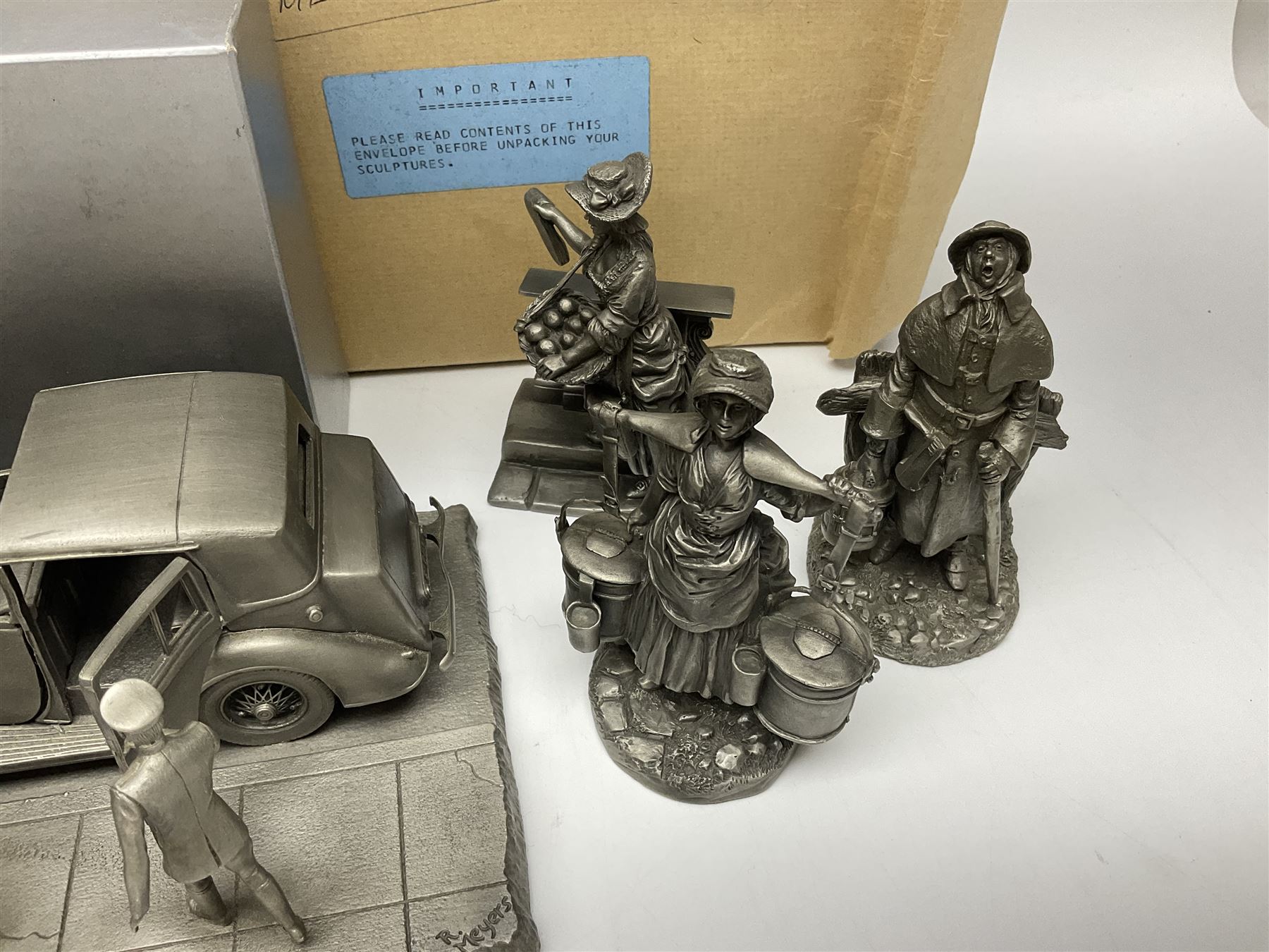 Twelve Franklin Mint pewter figures, to include some from the Cries of London series, together with a Franklin Mint 1937 Rolls Royce Phantom III pewter model and Danbury Mint Christmas bells