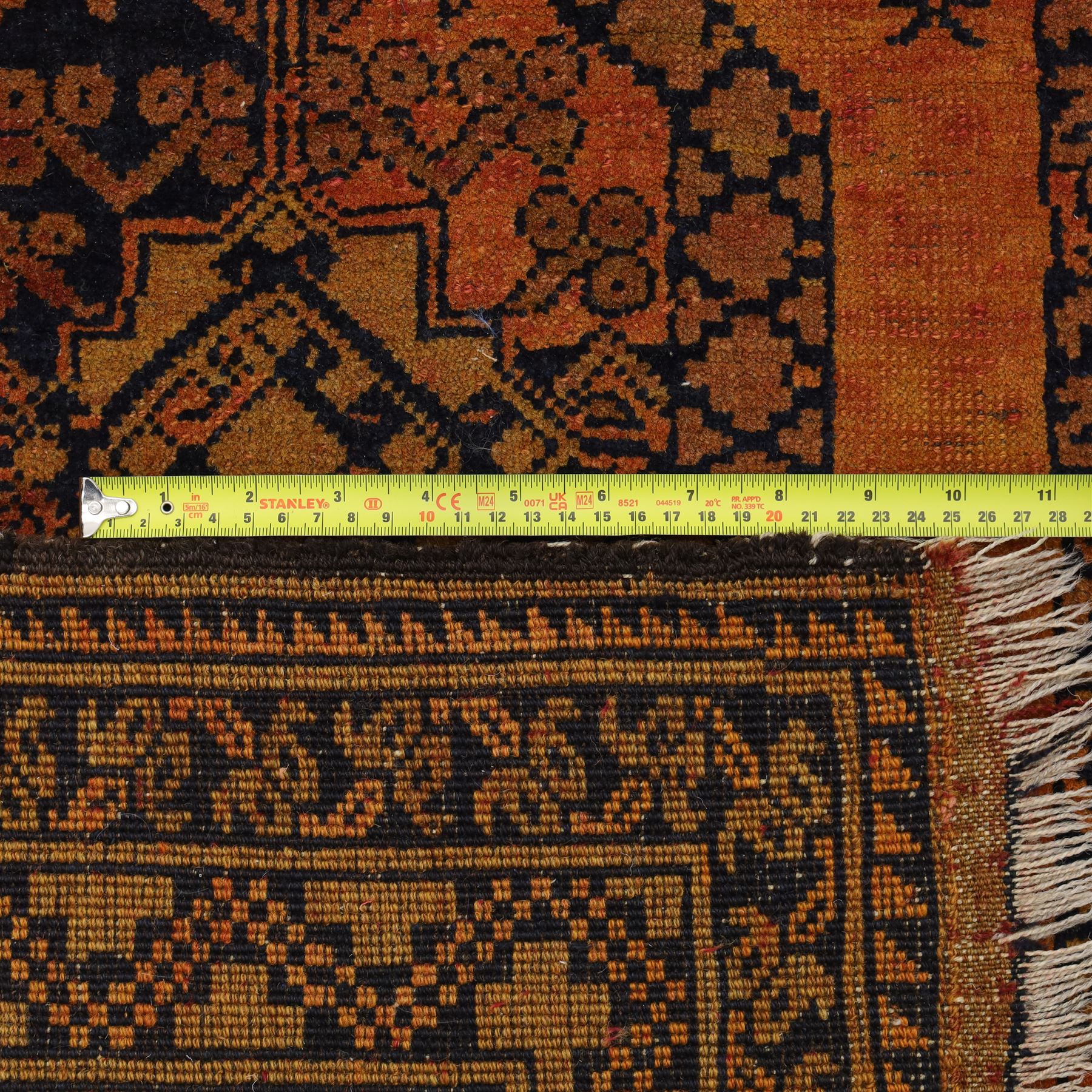Afghan Ersari hand-knotted rug, apricot field decorated with three large octagonal gul medallions filled with geometric floral motifs, flanked by small tribal devices, end fringe fraying 97x167cm, together with a Baluch prayer rug, decorated with stylized tree motifs arranged in vertical rows beneath a stepped mihrab arch with multiple narrow borders of angular tribal motifs in shades of indigo, brown, and ochre fraying to flatweave ends, 134x84cm, (2)