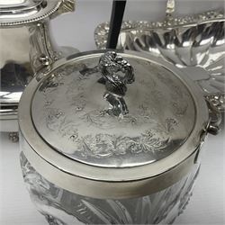 Edwardian silver plated swing handled basket, with pierced sides, engraved May 18 1904, with engraved initial A to handle, upon four ball and claw feet, together with other silver plated item including a similar swing handled basket, with embossed floral border, upon a rectangular pedestal, an egg coddler, with lion mask handles, hot water pot and a moulded glass biscuit barrel, coddler H22cm