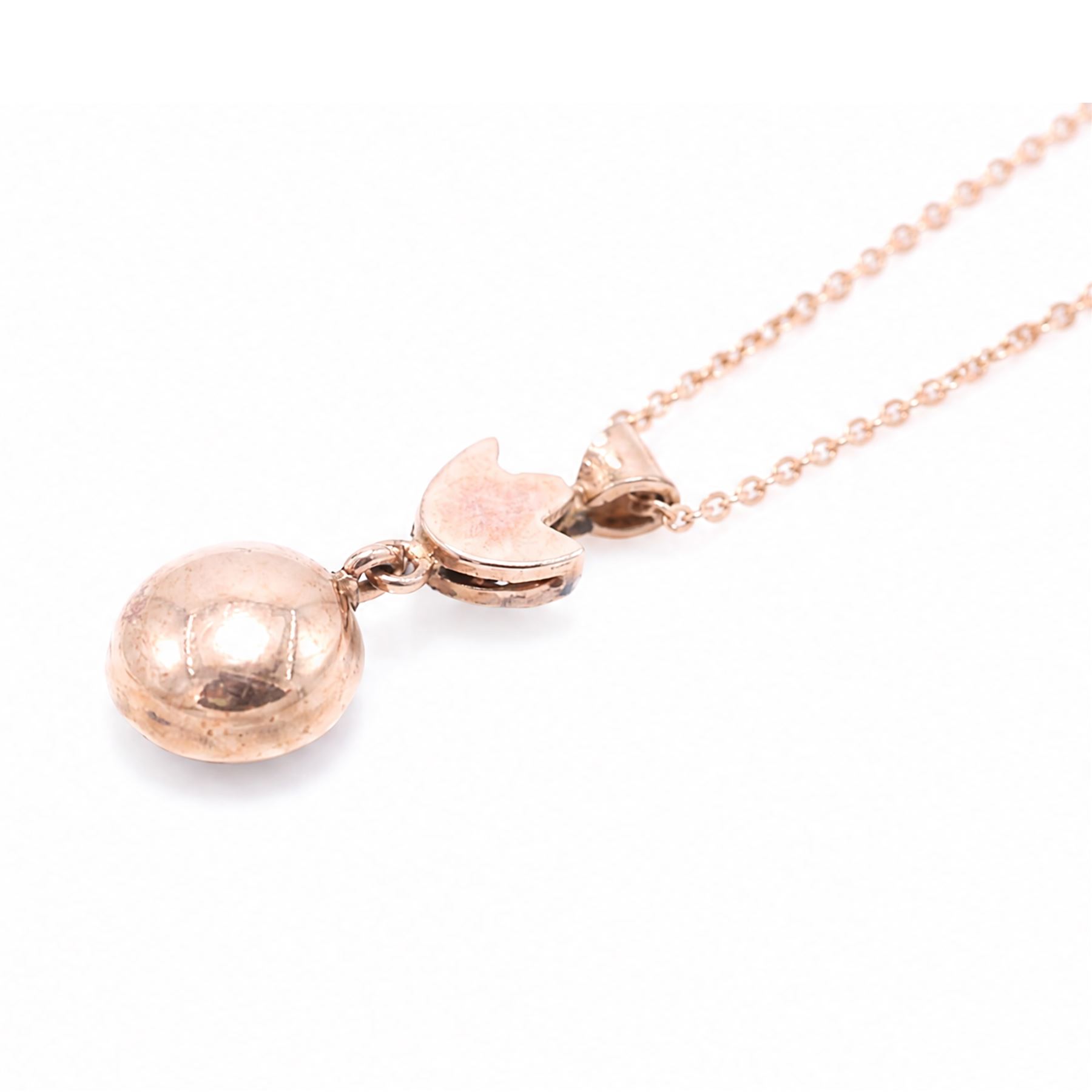 Gold and silver ruby and diamond pendant, single round brilliant cut diamond, surrounded by calibre cut rubies and round brilliant cut diamonds, suspending from a fancy pendant set with further diamonds, on a rose gold plated silver chain necklace, total diamond weight approx 0.30 carat, total ruby weight approx 0.30 carat