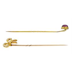 Two early 20th century gold stick pins, including a seed pearl set ribbon bow and cabochon garnet, one boxed