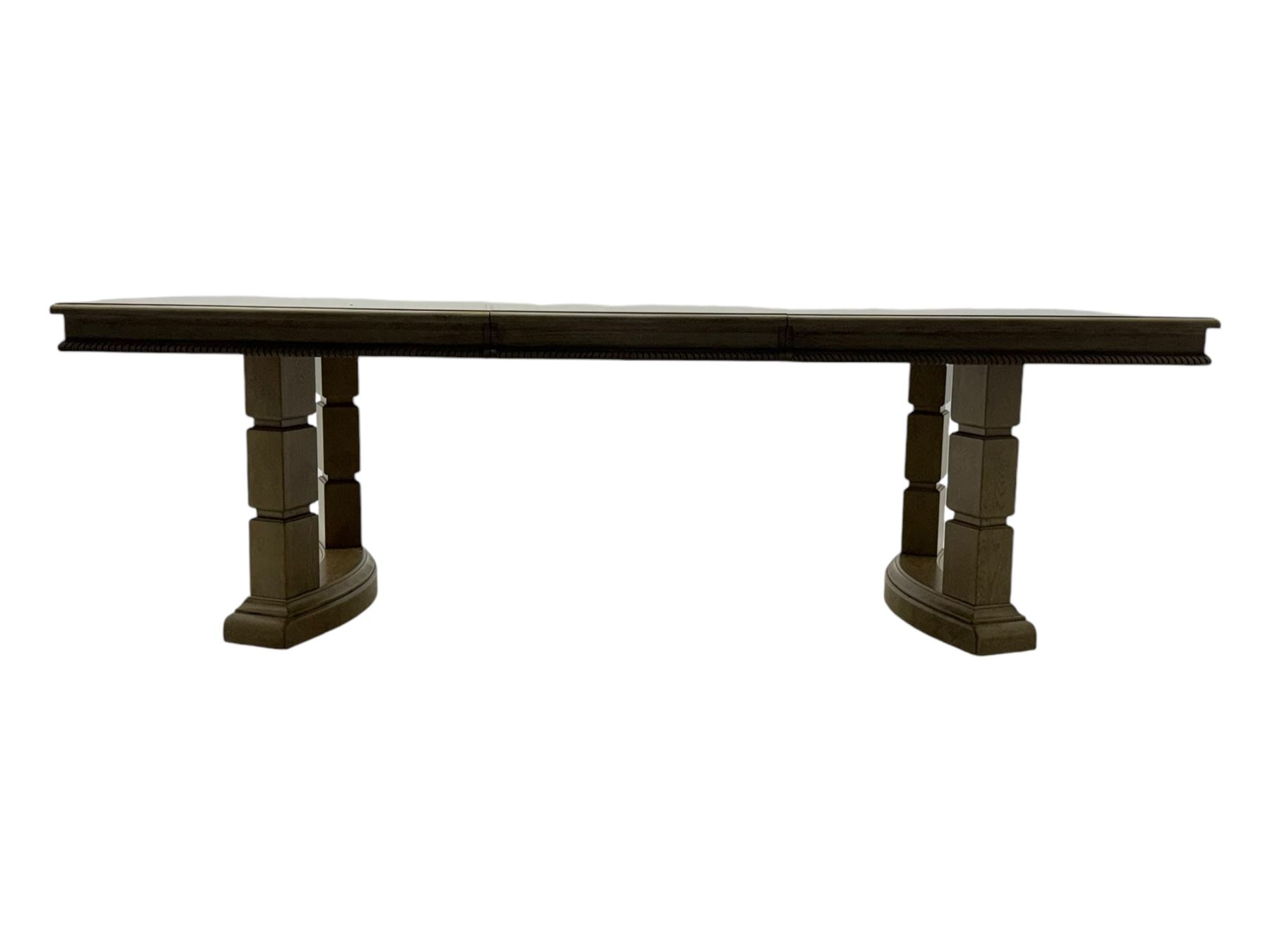 Brunswick - washed oak finish extending dining table, rectangular top with curved ends and carved frieze, central extension leaf, raised on twin pedestals with arched plinth bases and square-sectioned column supports; set of eight (6+2) high-back dining chairs upholstered in beige velvet fabric