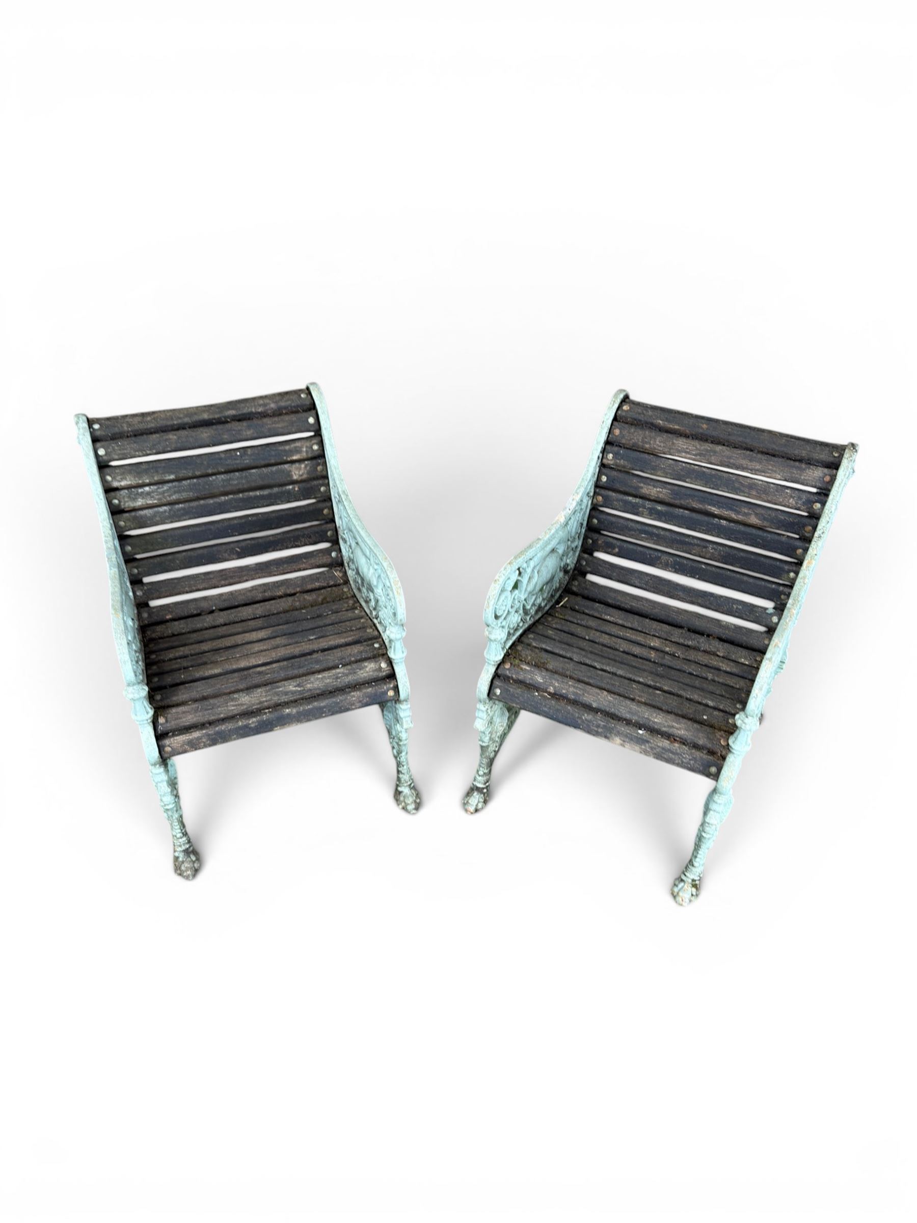 Pair of unusual Victorian revival heavy cast iron garden chair benches, ornate scrollwork detail with squirrels and nature, serpentine wood slatted seat and back - design by George Smith at the Sun Foundry, Glasgow