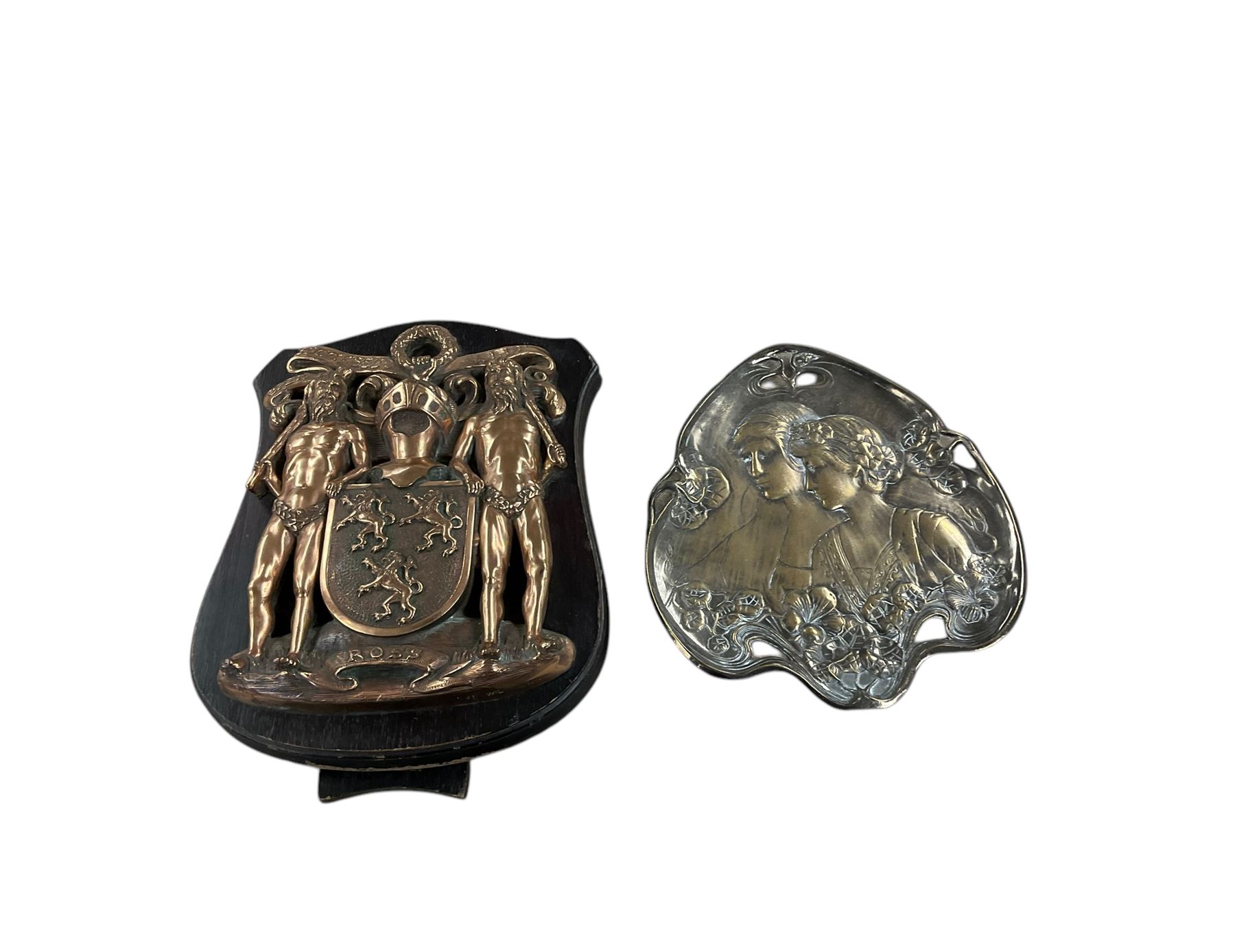 Bronze Ross family crest mounted on wooden strut frame, together with Art Nouveau card tray, after WMF, depicting two maidens amongst stylised flowers, tray H24cm