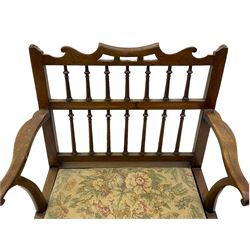 Late 18th century walnut 'Drunkard's' chair, the shaped cresting rail over spindle back, wide set seat with upholstered drop in cushion, shaped arms with scroll carved terminals, sledge supports with bracket feet joined by plain stretchers 