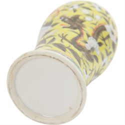 Pair of Chinese vases, of baluster form decorated with dragons amongst flowering peonies upon yellow ground, between bands of foliage, H24cm 