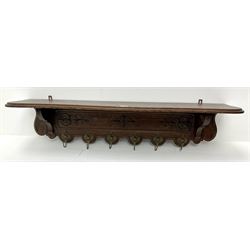20th century French oak wall hanging coat rack, relief carved with scrolls and acanthus leaves, six gilt hooks cast with masks