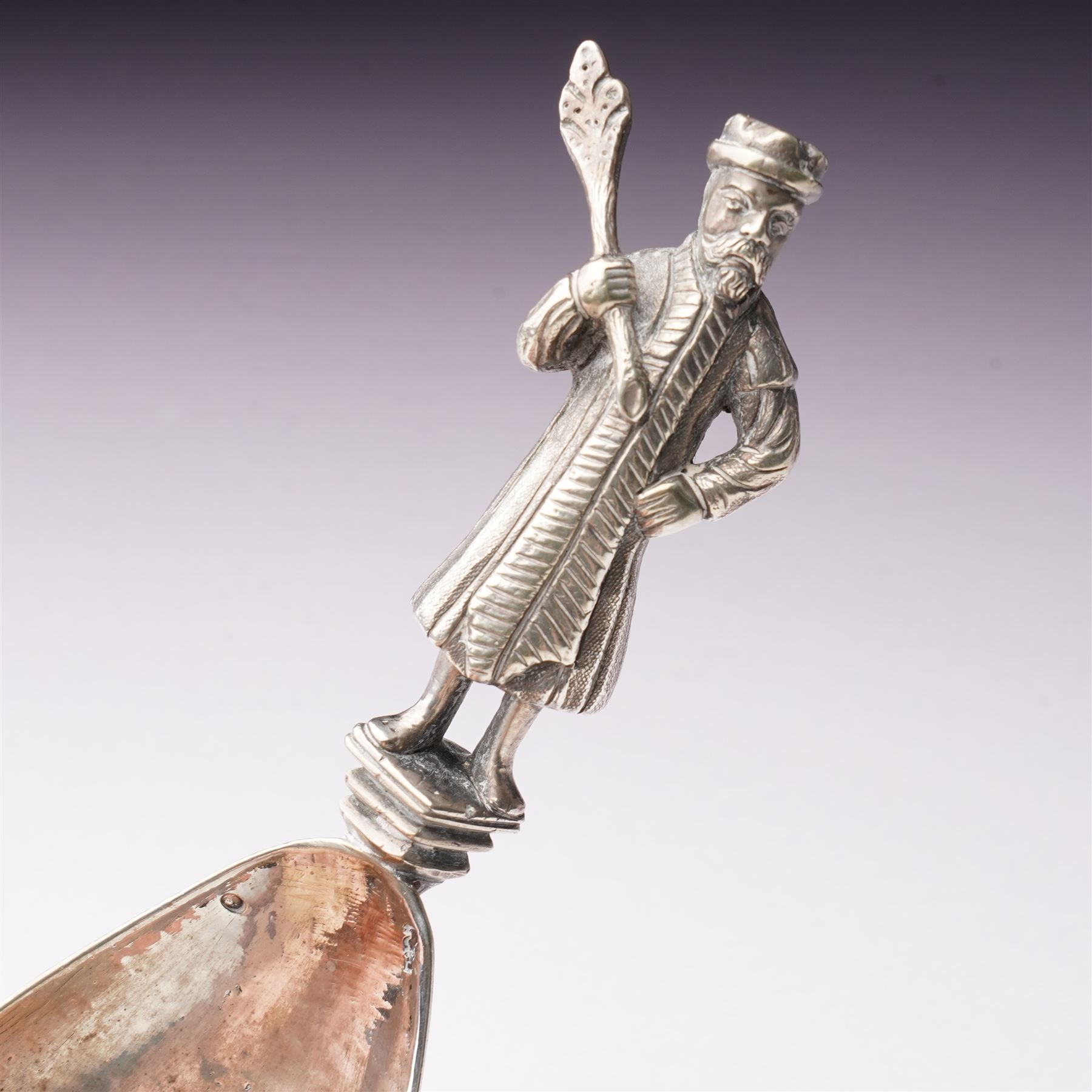 19th century Dutch silver spoon with hammered ovoid bowl, the reverse with a coat of arms, the stem formed as a standing figure after a 17th century design L13cm