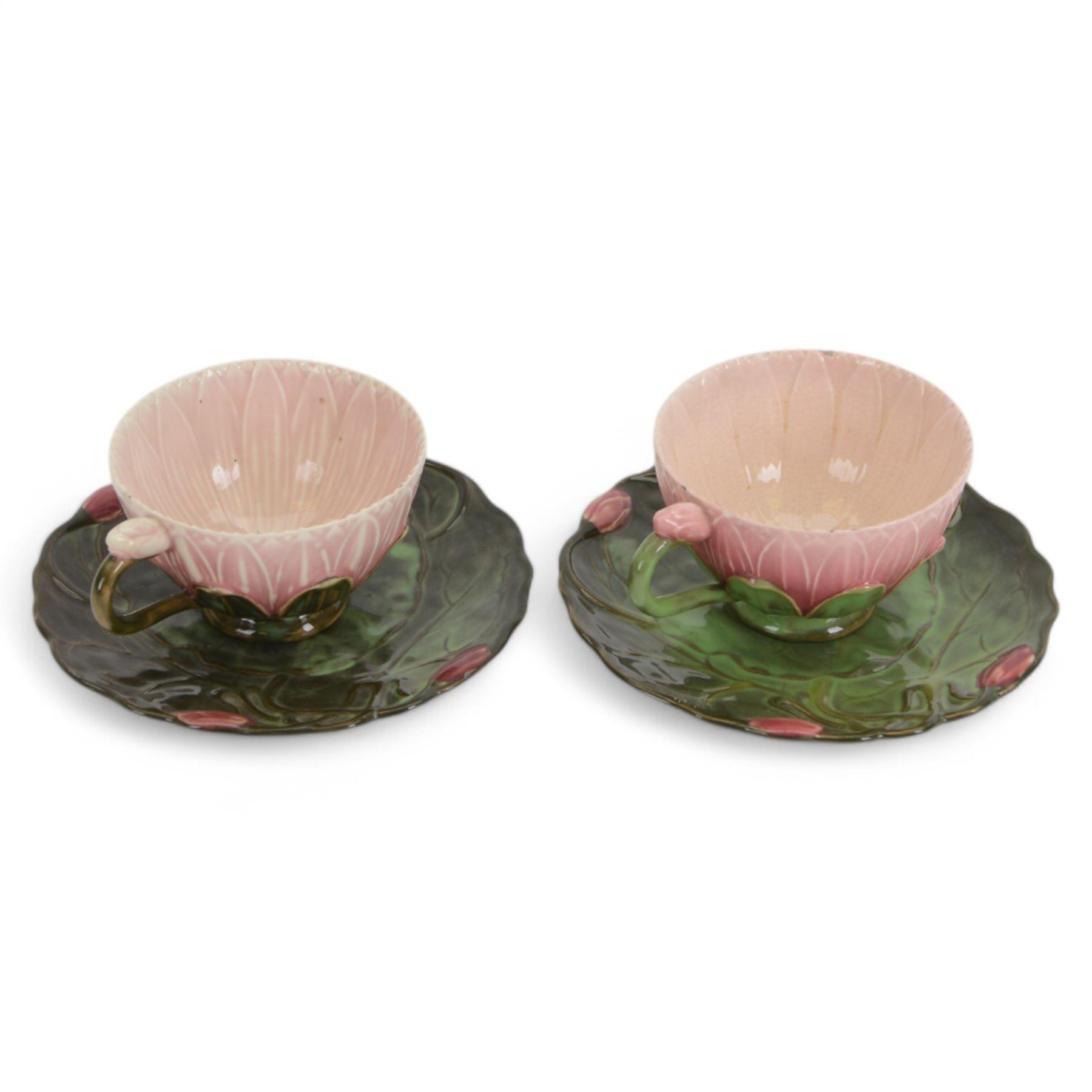 Two Zsolnay Pecs lotus moulded teacups and saucers, with impressed mark beneath