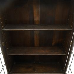 Early 20th century Jacobean Revival oak bureau-bookcase, astragal glazed doors enclosing two adjustable shelves, over geometric panelled fall-front enclosing fitted interior, over two drawers, raised on a spiral-turned base with barley-twist stretchers and compressed bun feet
