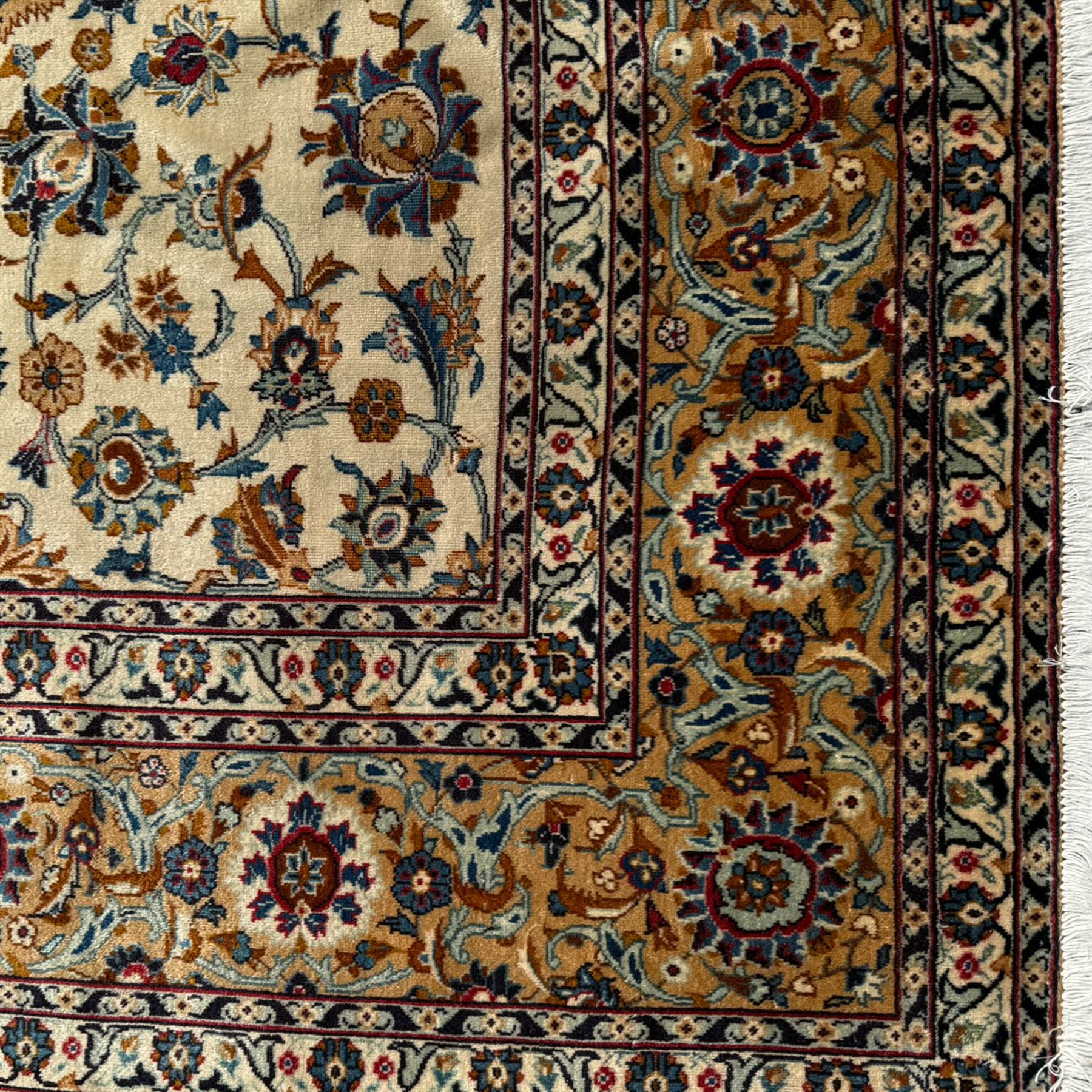 Kashan Persian rug, hand knotted, ivory ground rug, the rosette medallion decorated with projecting palmettes, on a field of swirling leafy branches and decorated with further palmettes, the scrolling border with repeating stylised plant motifs, within floral pattern guard stripes
