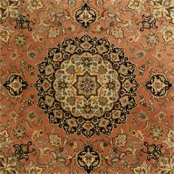 Persian Kashan style rug, salmon pink ground, central conforming lobed medallion in ivory and indigo, with palmette pendants, framed scrolling arabesques of lotus blossoms and palmettes, within navy border of meandering vines and flowerheads between ivory guard stripes 