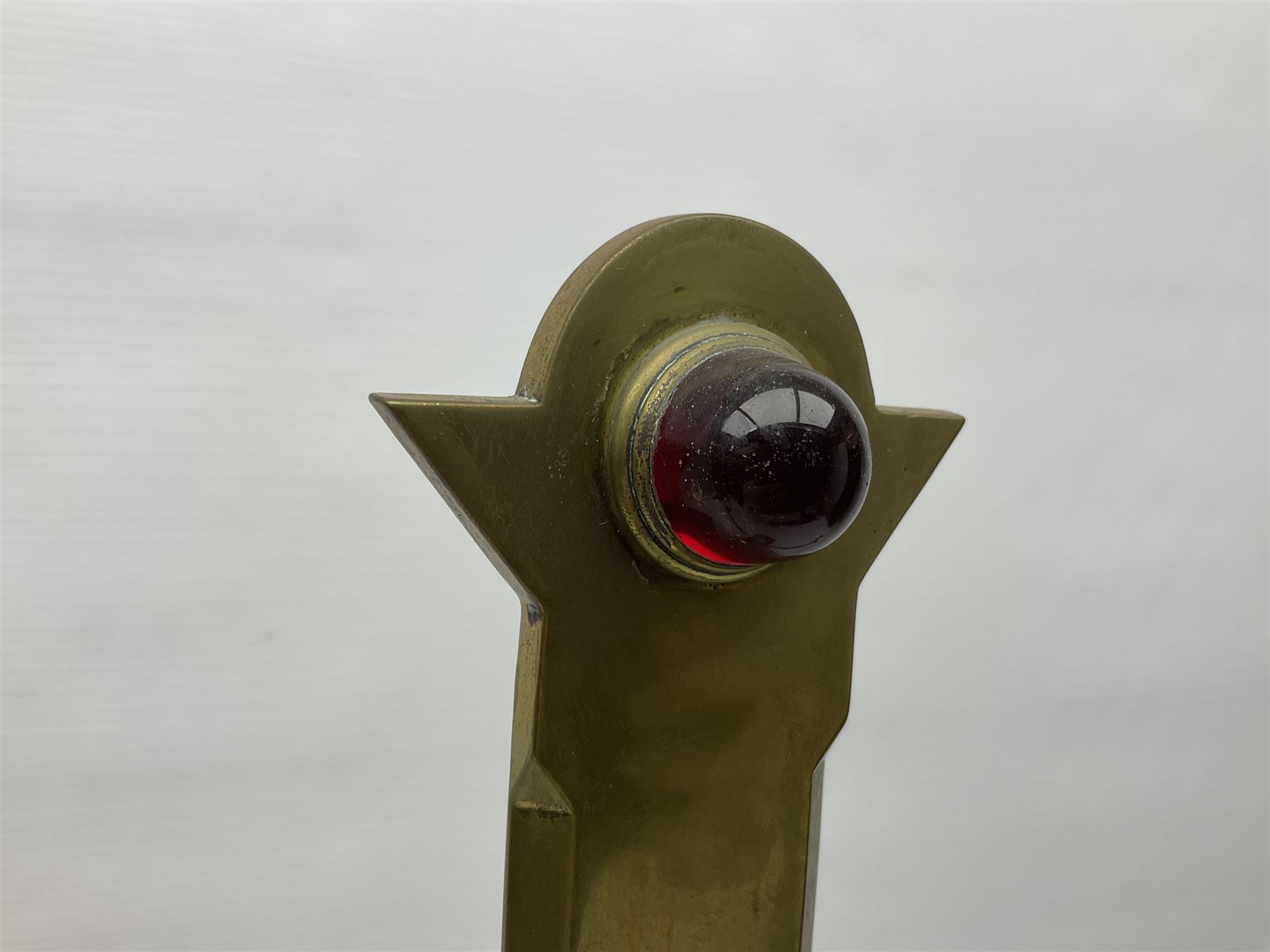 Brass alter cross, decorated with glass cabochons, upon a acicular stepped base and three claw feet, H73cm 