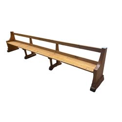 Early 20th century ecclesiastical pine bench or church pew, raised on chamfered supports with sledge feet