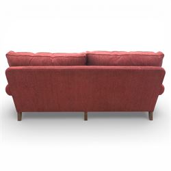 Late 20th century three seat sofa upholstered in red fabric, with gently rounded scroll arms, loose seat and back cushions, raised on tapered wooden legs
