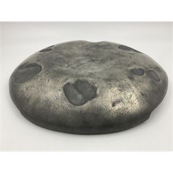 Liberty & Co Tudric pewter Bollelin tray, designed by Archibald Knox, of circular form with shaped edge, cast in relief with foliate tendrils surrounding a green enamel cartouche, impressed beneath Made by Library & Co English Pewter 044, D25.5cm